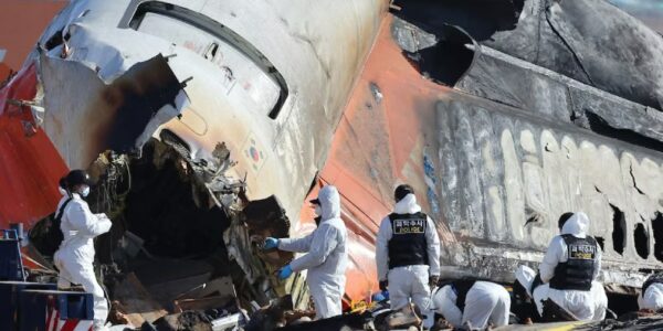 Wreckage of a crashed airplane with rescue teams responding