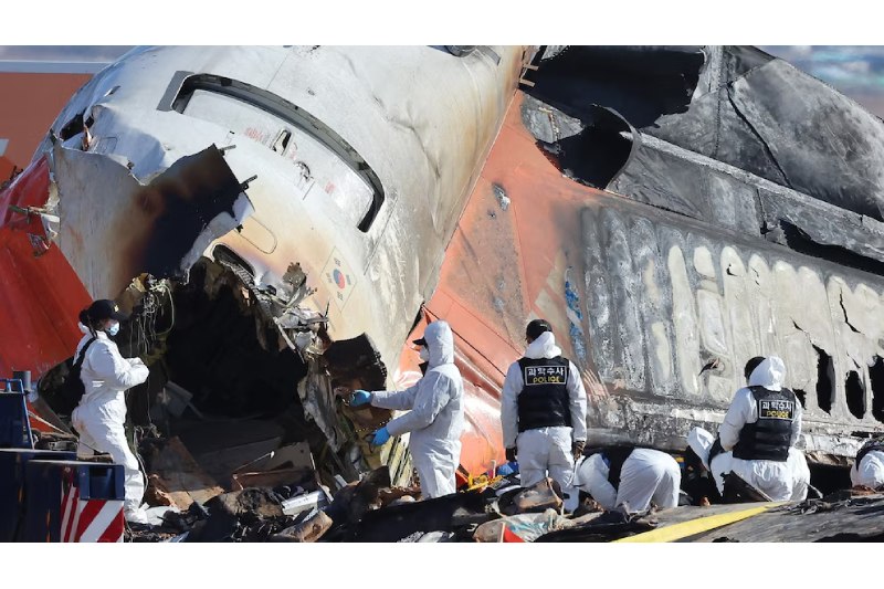 Wreckage of a crashed airplane with rescue teams responding